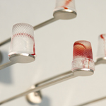 Silent languages, Chapter 4: Family history, installation MusVerre, Sars-Poteries, detail, pâte de verre, stainless steel, magnets, 2021-2022 (photo: Philippe Robin)