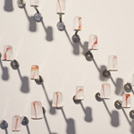 Silent languages, Chapter 4: Family history, installation MusVerre, Sars-Poteries, detail, pâte de verre, stainless steel, magnets, 2021-2022 (photo: Philippe Robin)
